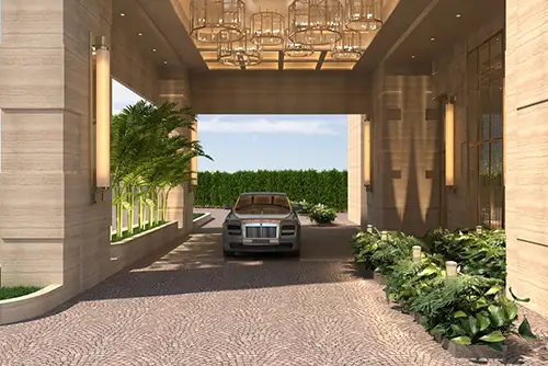 Grand entrance of Signature Global Tonino Lamborghini Residences in Sector 71 Gurgaon featuring Rolls-Royce car, decorative ceiling lights, cobblestone driveway, and lush greenery.